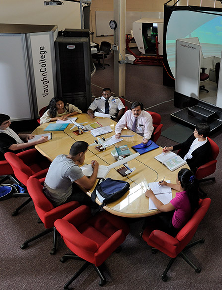 Students and teacher meeting at a table