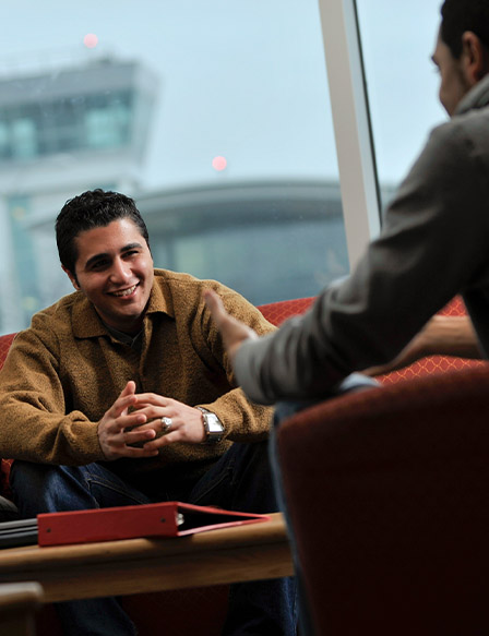 Two men talking on campus