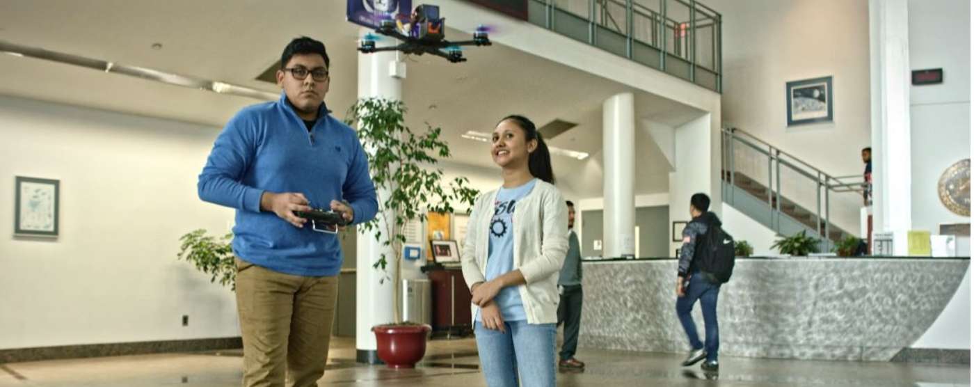 Students flying drone in Vaughn lobby