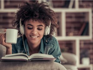 African American girl relaxing reading book