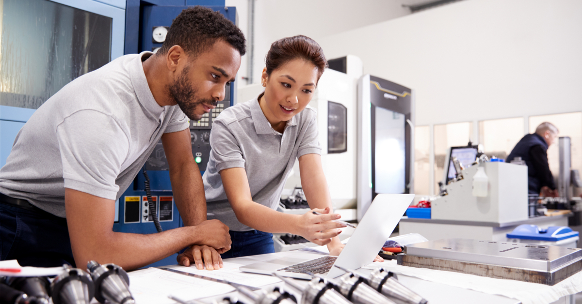 Two engineers looking at CAD software