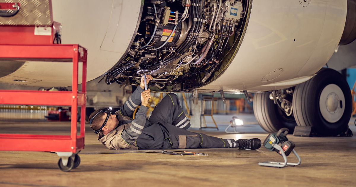 Aviation Maintenance Technician working on plane