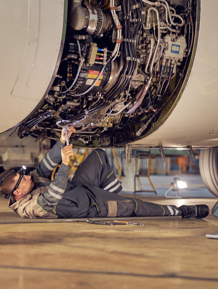Aviation Maintenance Technician fixing a plane