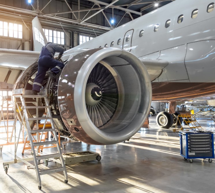 fixing an airplane engine in hangar